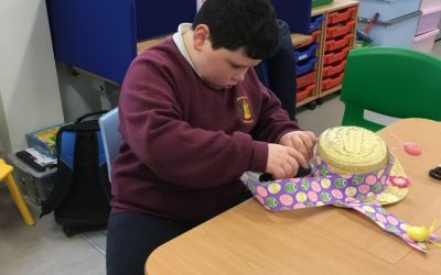 Putting the finishing touches on our scarecrow’s Easter bonnet.