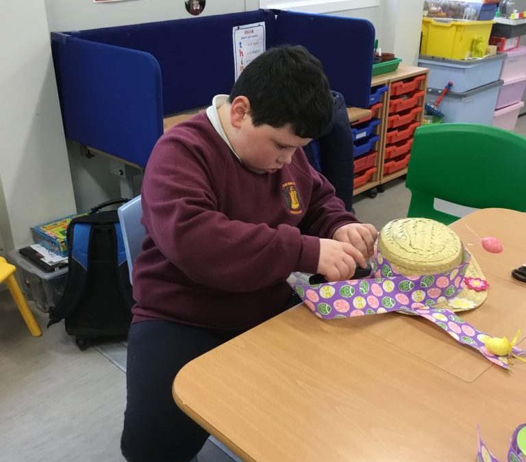 Putting the finishing touches on our scarecrow’s Easter bonnet!